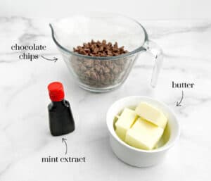 Chocolate Butter Ganache Layer Ingredients on White Marble Surface