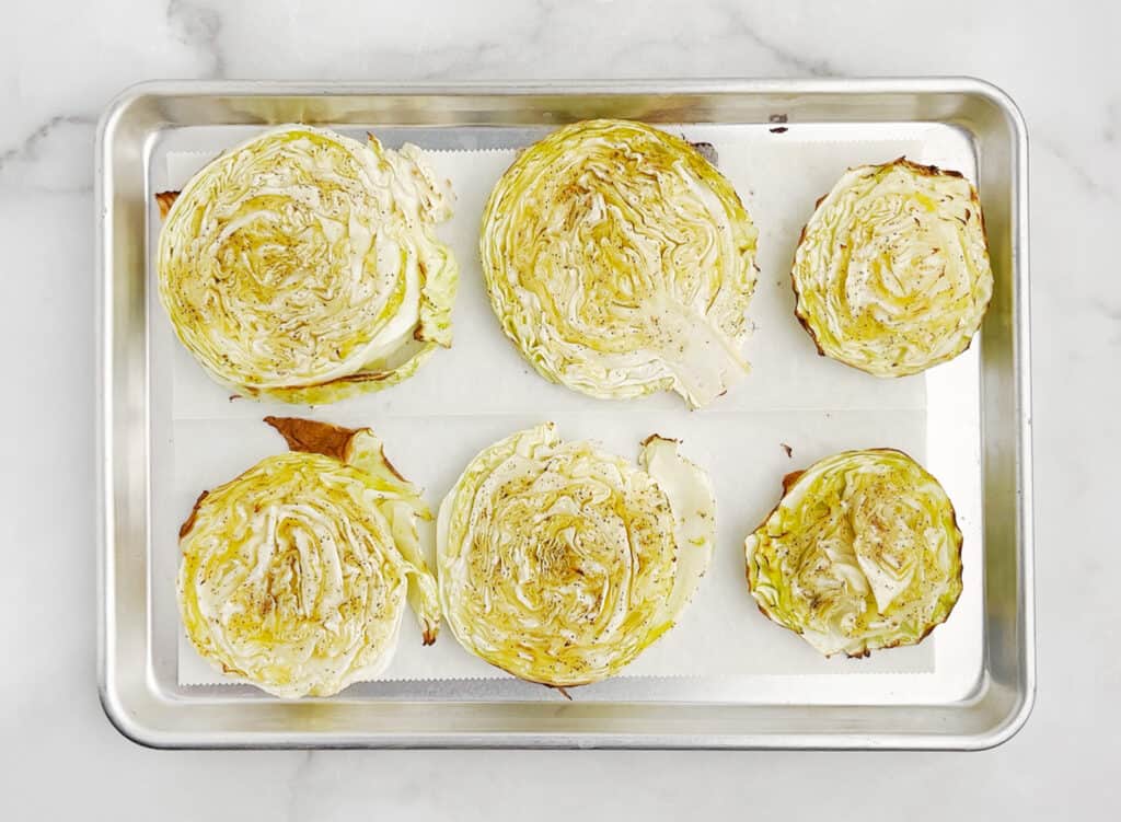 Fully Cooked Cabbage Steaks on Baking Sheet with Parchment