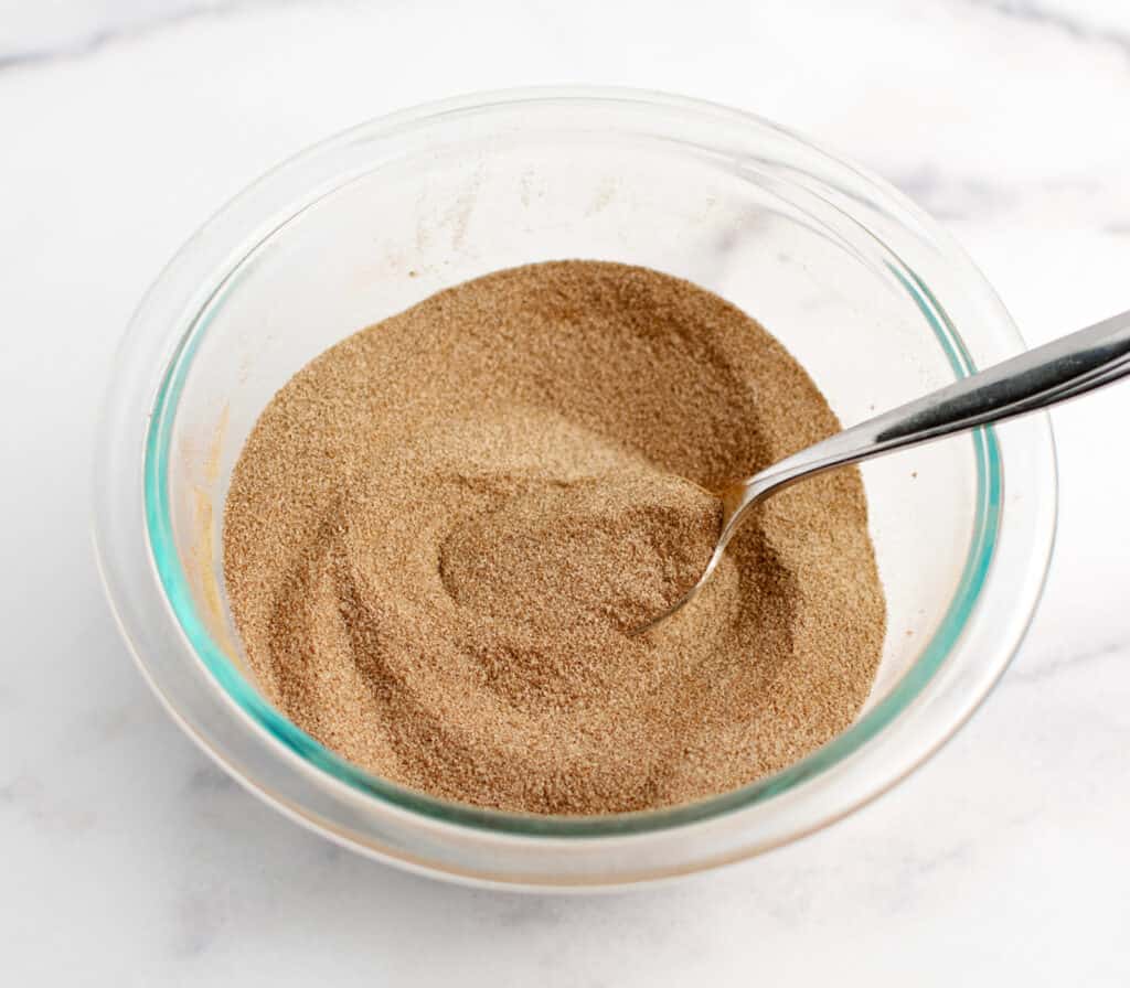 Cinnamon Sugar Mixed in Bowl with Spoon on Marble Surface