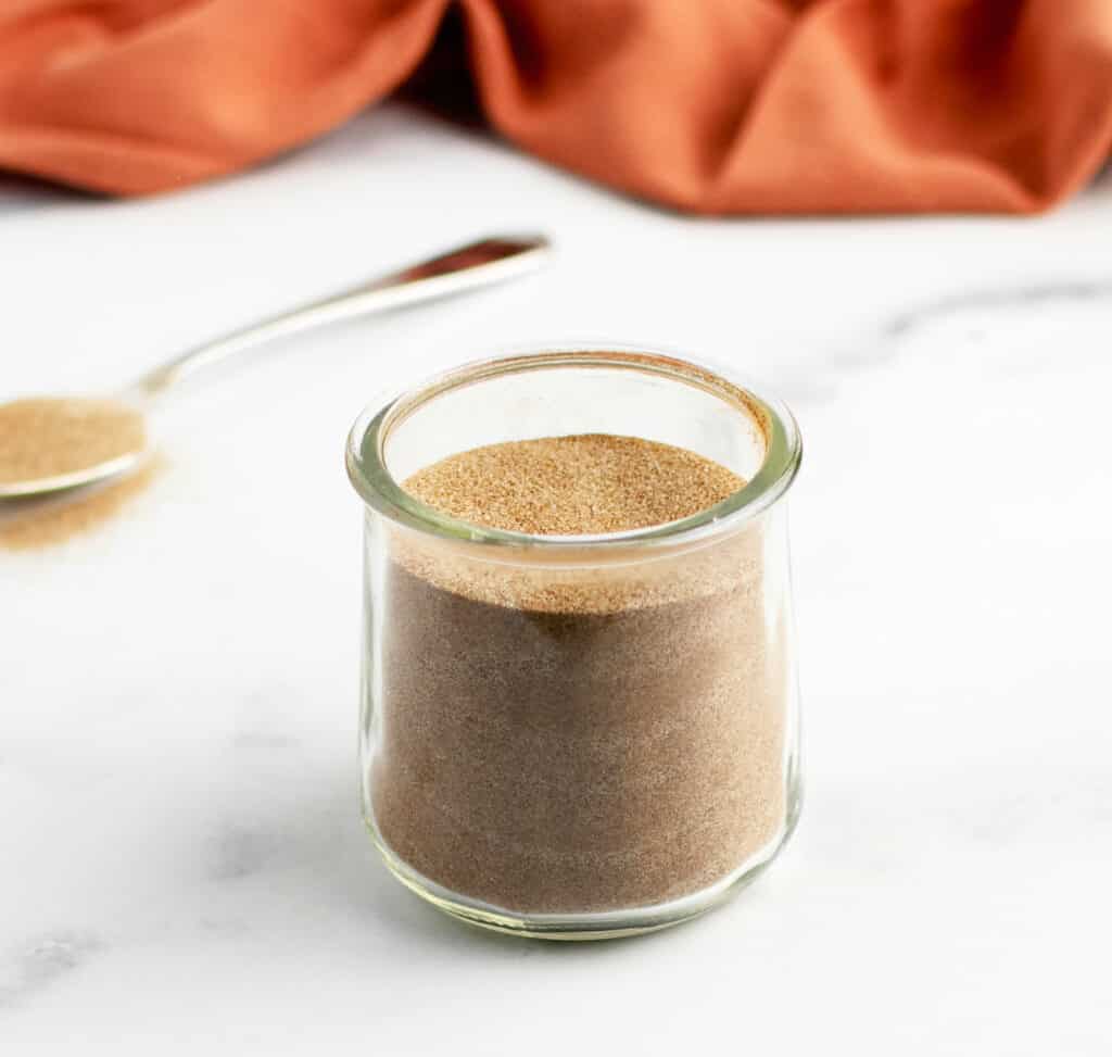 Cinnamon Sugar in Jar  with Pumpkin Kitchen Towel in Background