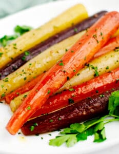 Honey Glazed Roasted Rainbow Carrots on White Platter with Parsley Closeup