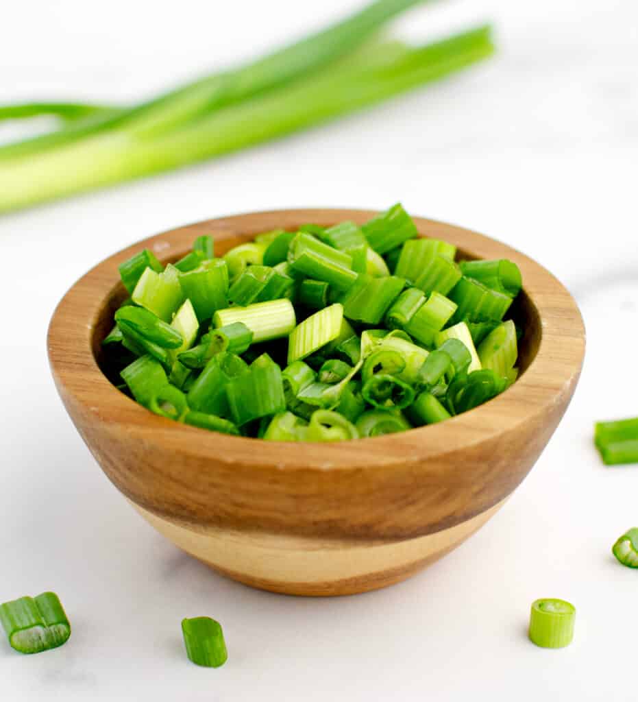 Green Onions in Bowl with Green Onion in Background