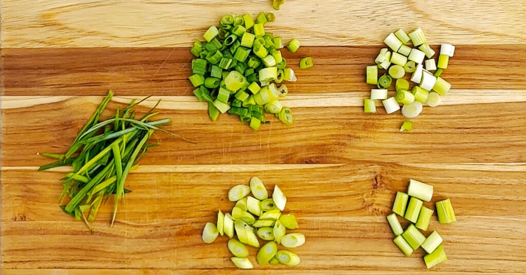 Green Onions Cut 5 Different Ways on a Wooden Cutting Board