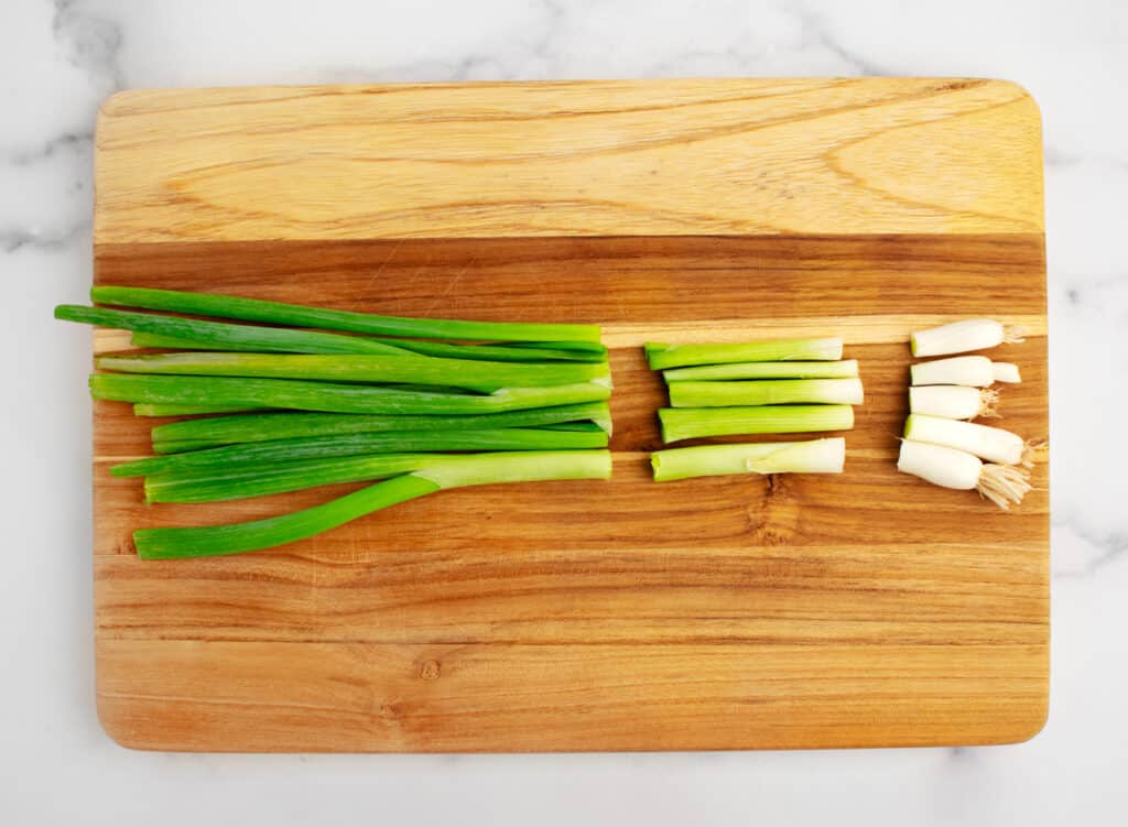 Separated Parts of Green Onion on Wooden Cutting Board