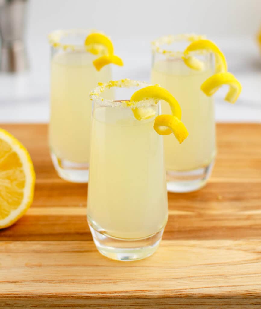 Lemon Drop with Lemon Twists on Wooden Cutting Board