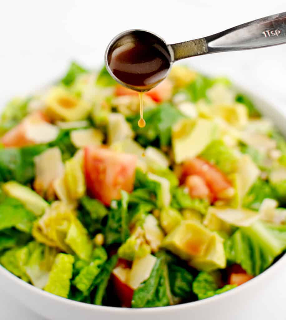 Drizzling Dressing Over Salad with Spoon