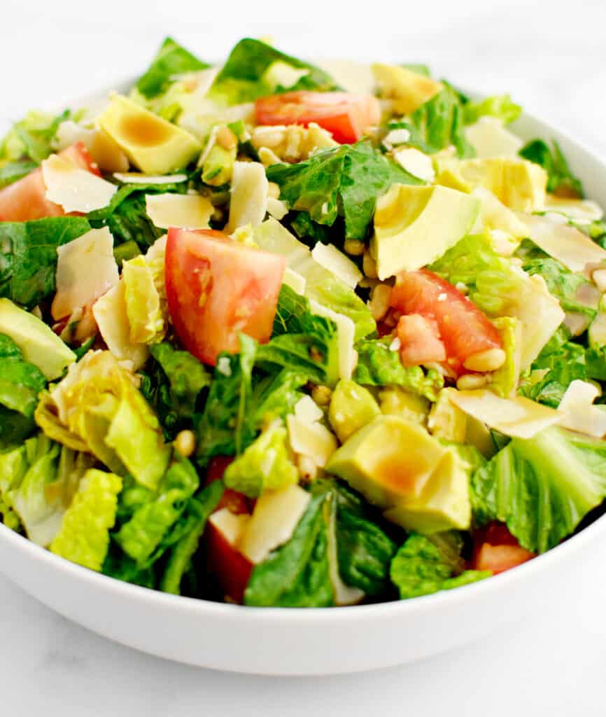 Avocado Tomato Romain Salad Finished in White Bowl