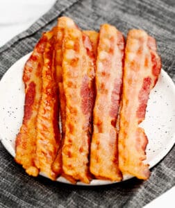 Oven Baked Bacon on Plate with Grey Napkin in Background