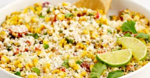 Mexican Street Corn Salad in White Bowl with Limes