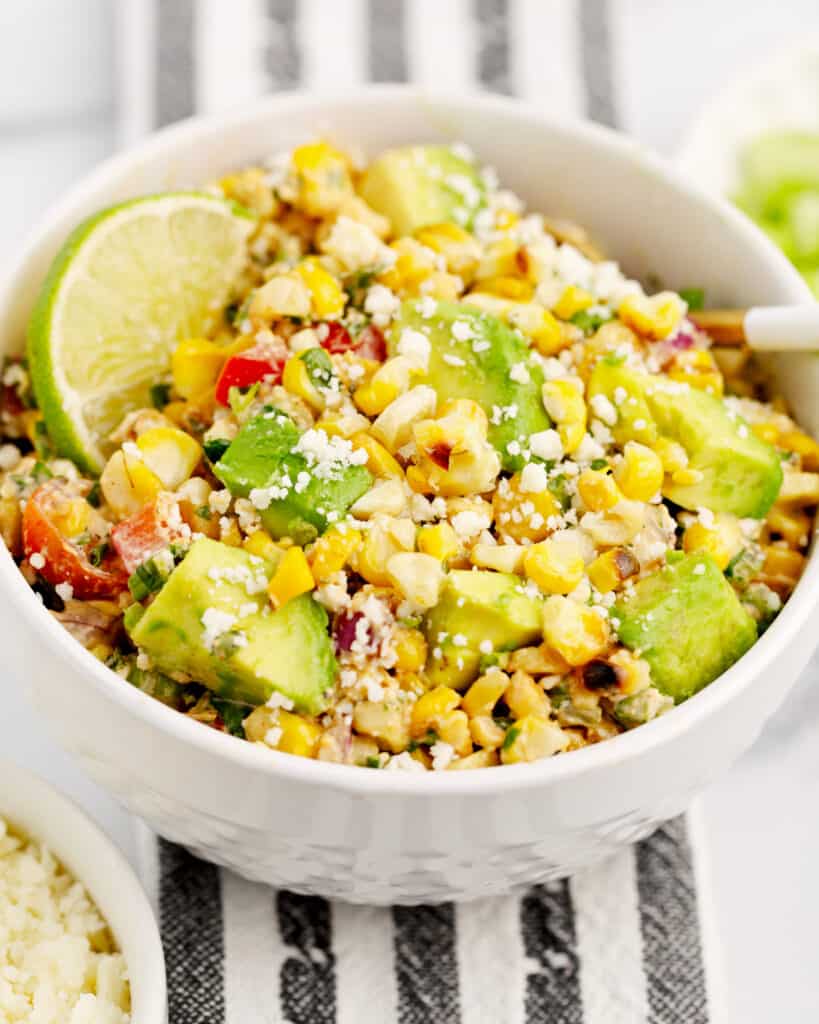 Mexican Street Corn Salad in Bowl on Striped Kitchen Towel