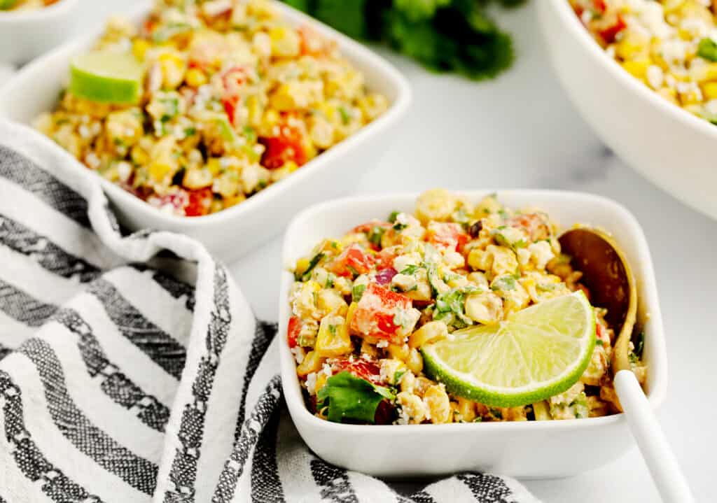 Corn Salad in White Bowls with Gold and White Spoon