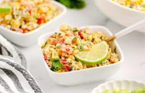 Individual Serving of Mexican Street Corn Salad in White Bowl with Spoon