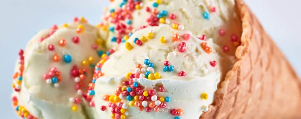 Rainbow Sprinkles on Ice Cream in Waffle Cone