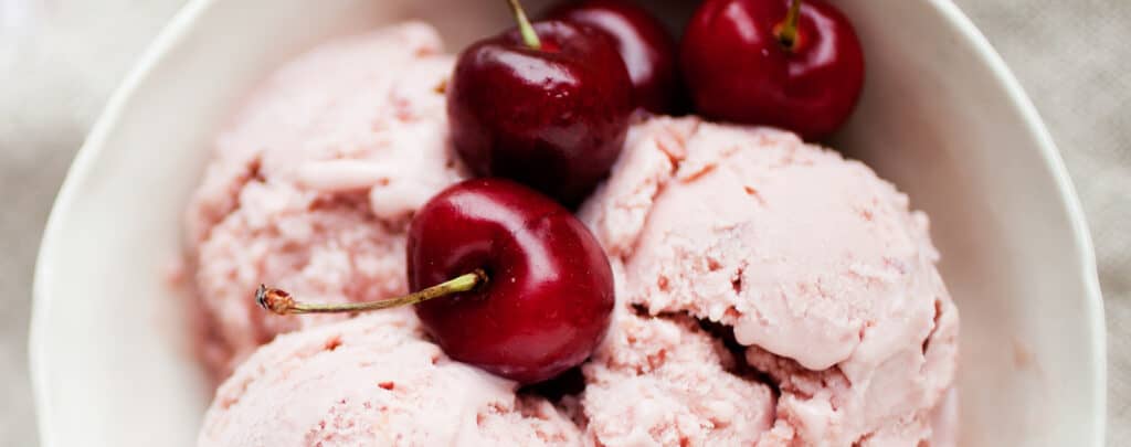 Fresh Cherries on Ice Cream in Bowl