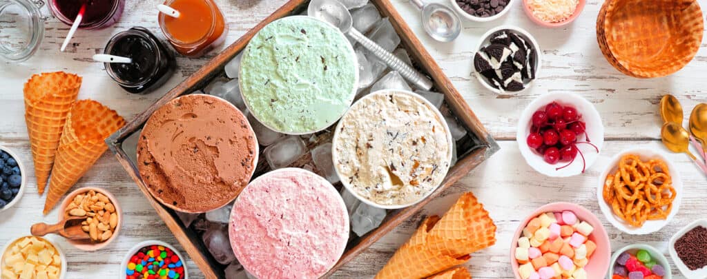 Variety of Ice Cream Flavors and Toppings Set Out for Ice Cream Sundae Bar