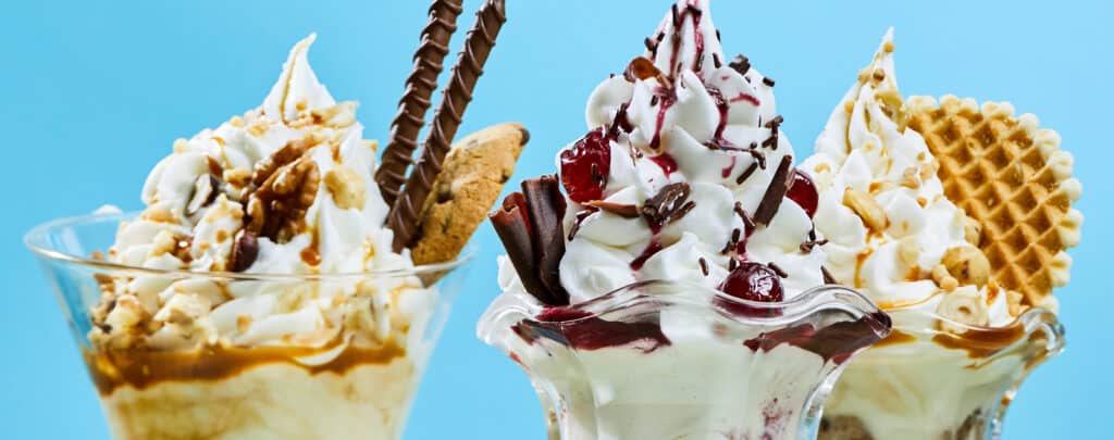 Variety of Ice Cream Sundaes with Sauces and Toppings