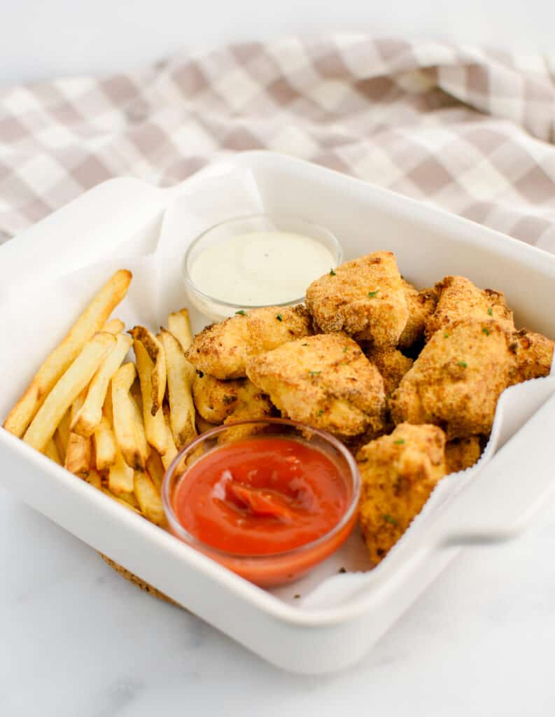 Air Fried Chicken Nuggets in Dish with Fries and Dipping Sauces