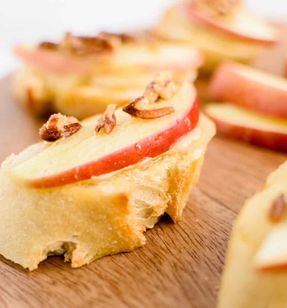 Brie, Apple, and Honey Crostini on Wooden Serving Stand Closeup