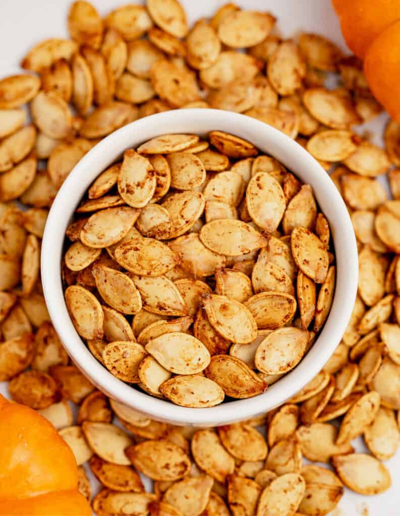 Roasted Pumpkin Seeds in Bowl with Seeds Surrounding