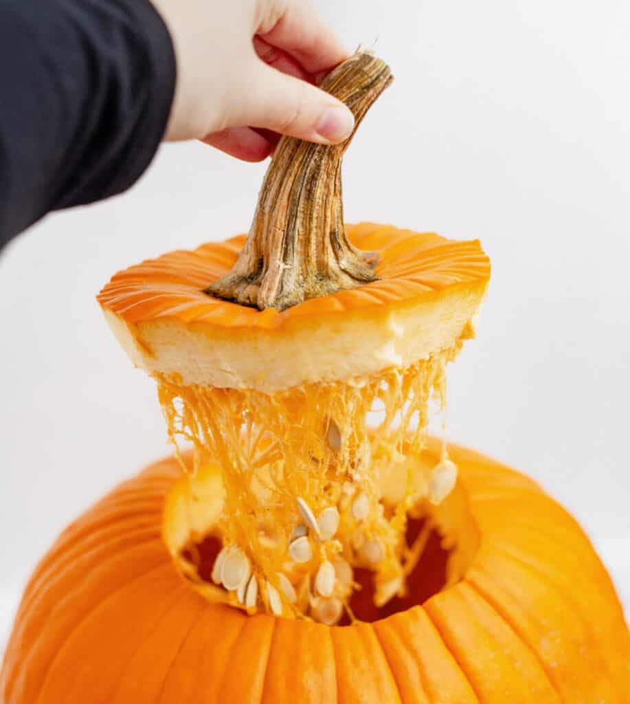 Removing Top of Pumpkin with Stem After Cutting Open