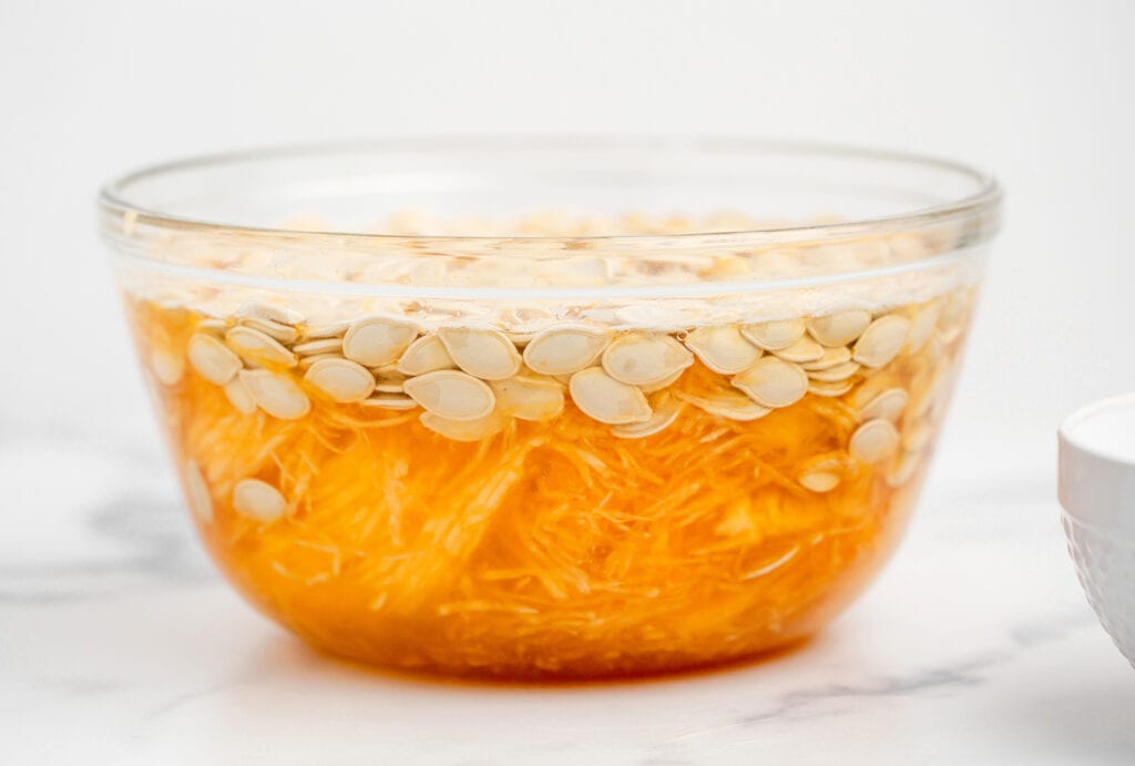 Bowl of Water with Pumpkin Seeds and Guts