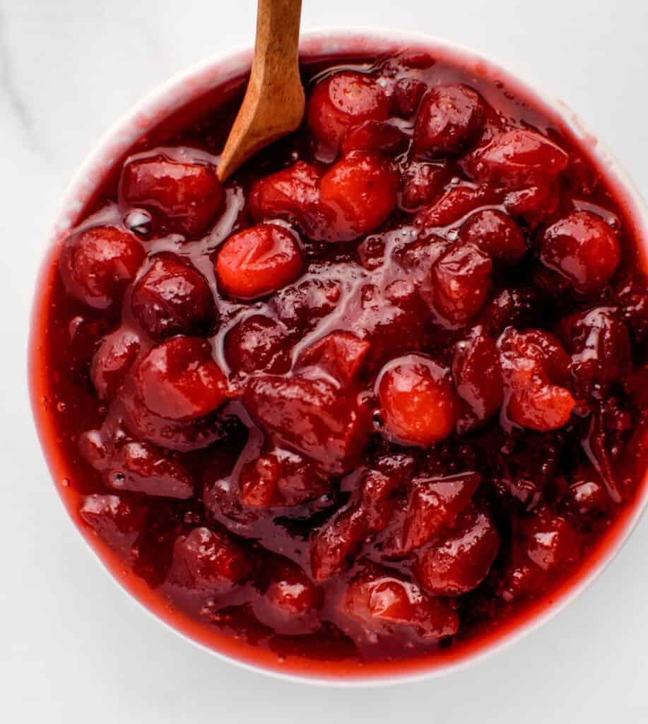 Top View of Cranberry Sauce in Bowl with Wooden Spoon