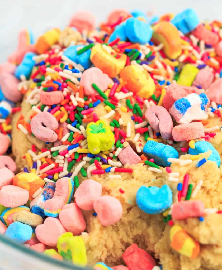 Sprinkles and Lucky Charms Marshmallows on Top of Cookie Dough