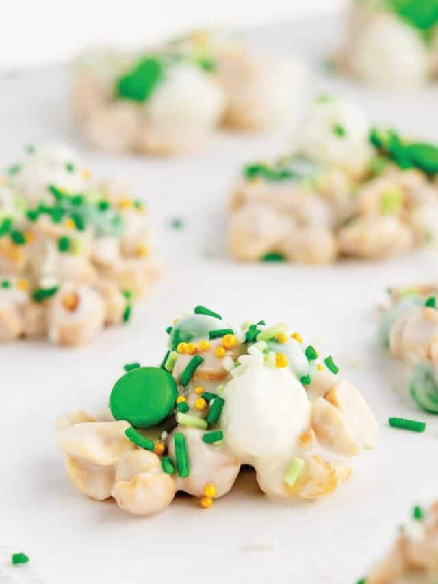 Crockpot Candy with Green M&Ms and sprinkles on parchment paper