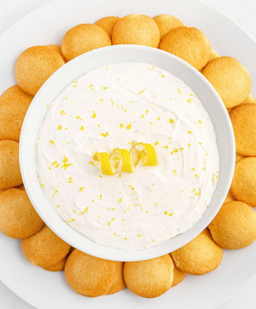 Lemon Cheesecake Dip with Wafer Cookies Around It on a Plate