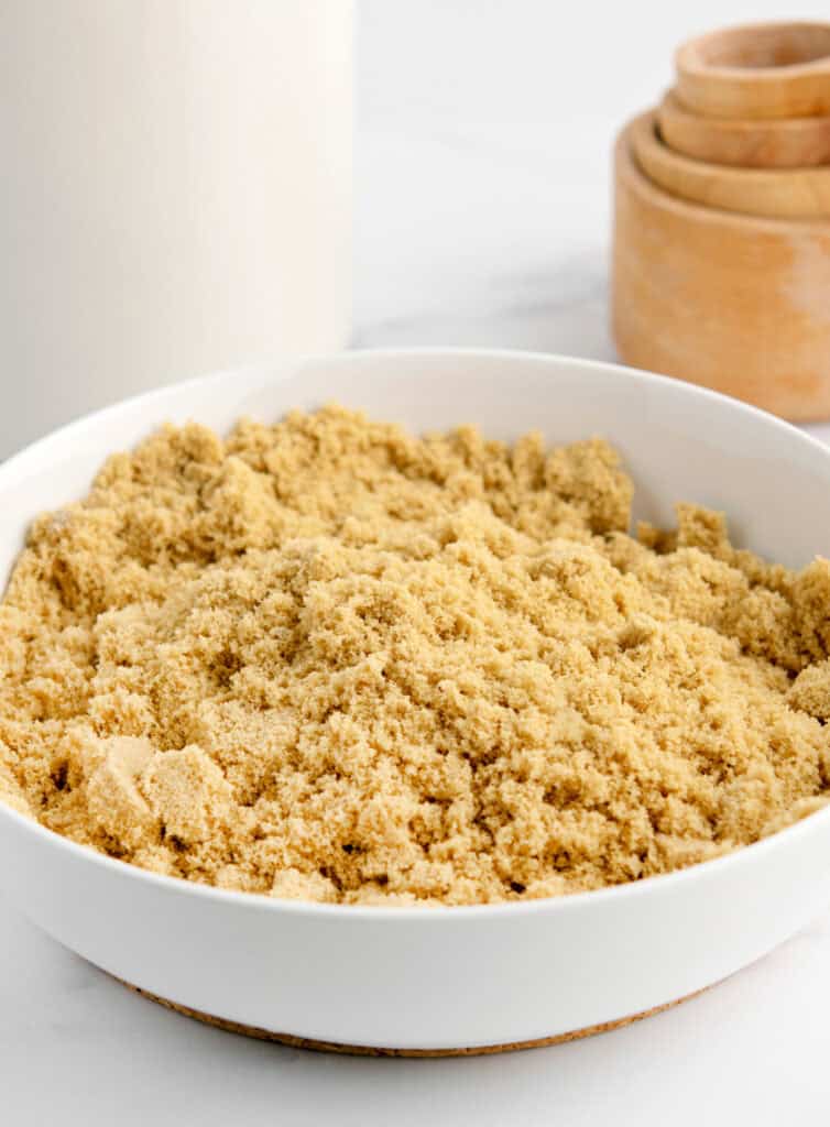 Soft Brown Sugar in White Bowl with Measuring Cups in Background